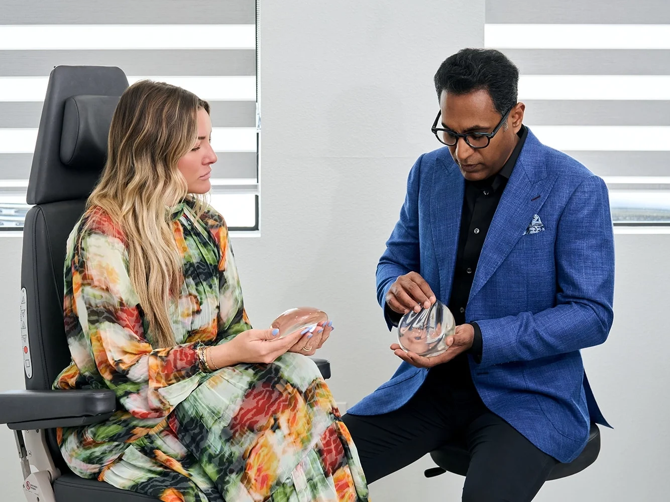 Dr. Solomon showing a patient examples of breast implants