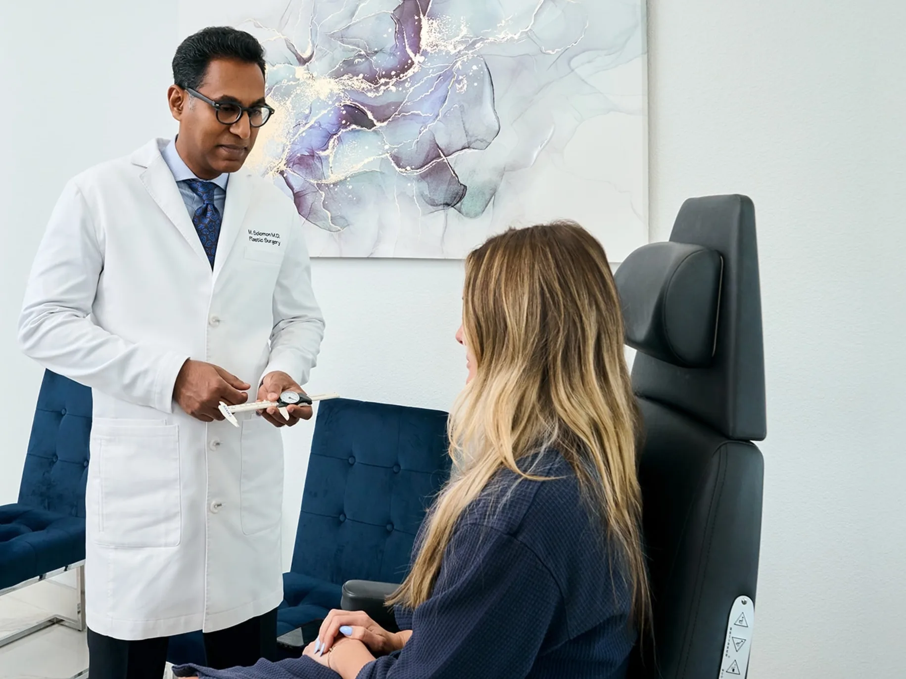Dr. Solomon with a customer in the Frisco, TX office.