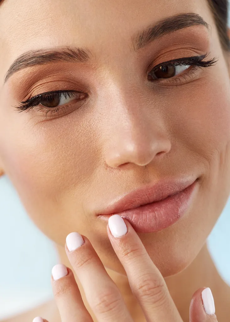 Stock beautiful skin touching lips