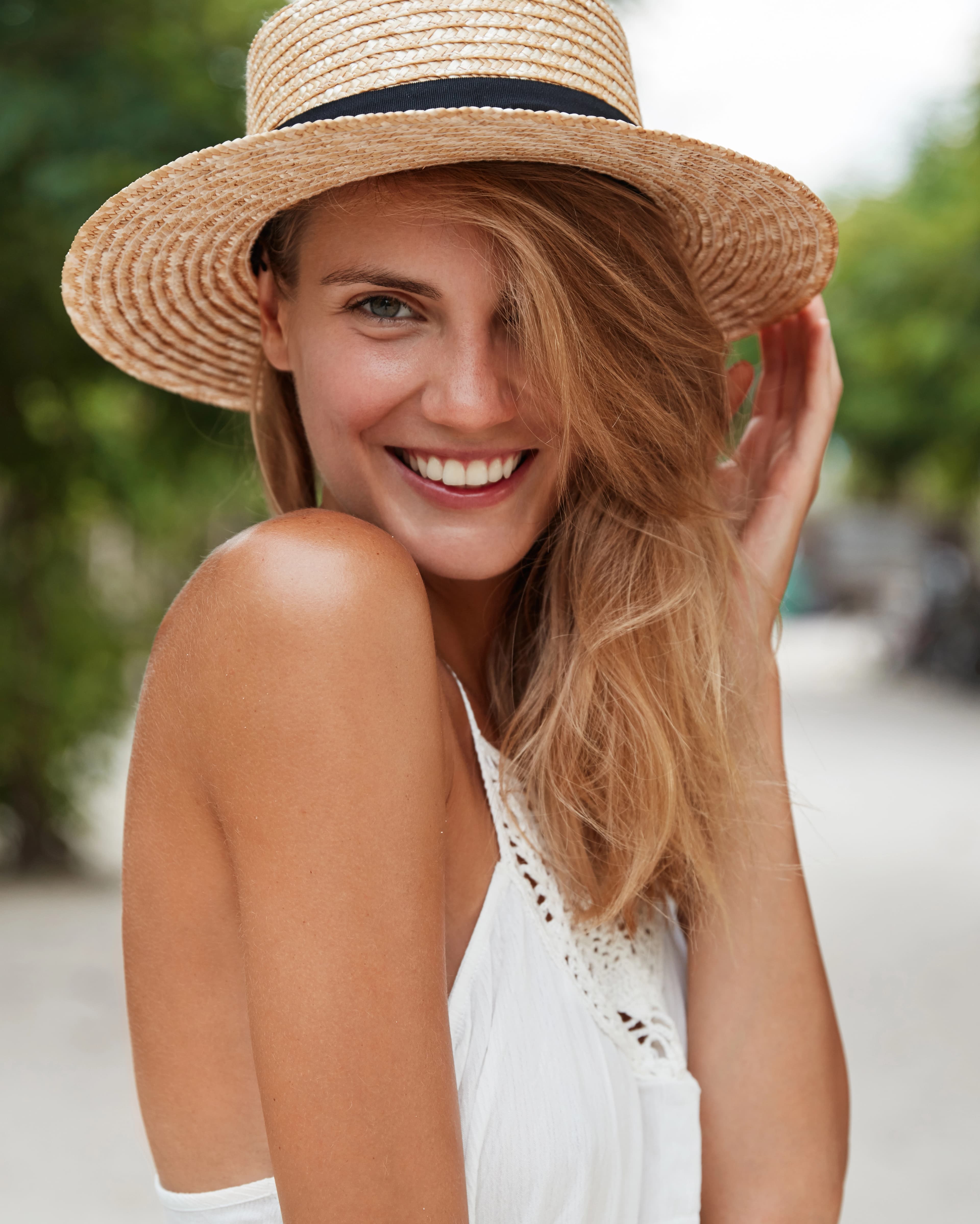 happy woman wearing a hat